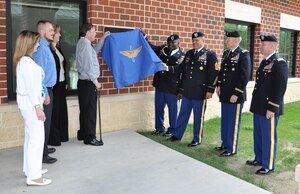 Leaders from the 128th Aviation Brigade and members of retired U.S. Army Command Sgt. Maj. Richard Lee Jackson’s family unveil a plaque during the dedication of Jackson Hall at Fort Eustis, Va., May 21, 2013. The brigade dedicated the first of several  forthcoming Soldier barracks in Jackson’s honor for his service to the U.S. Army Transportation and Aviation Logistics School, and later, the U.S. Army Aviation Logistics School, the brigade’s predecessor. (U.S. Air Force photo by Tech. Sgt. April Wickes/Released)  