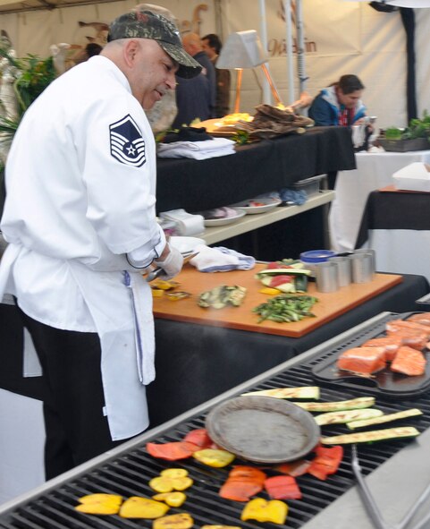 Master Sgt. Robert Shulman, 446th Force Support Squadron sustainmentservices flight manager, McChord Field, Wash., demonstrates culinary skillduring Alaska Air Cargo's annual Copper Chef Cook-Off May 17 in Seattle.Shulman prepared his balsamic and agave nectar glazed Copper River salmon recipe for judges and spectators, earning him a silvermedal in the competition. (U.S. Air Force photo by 1st Lt. Lori Fiorello)
