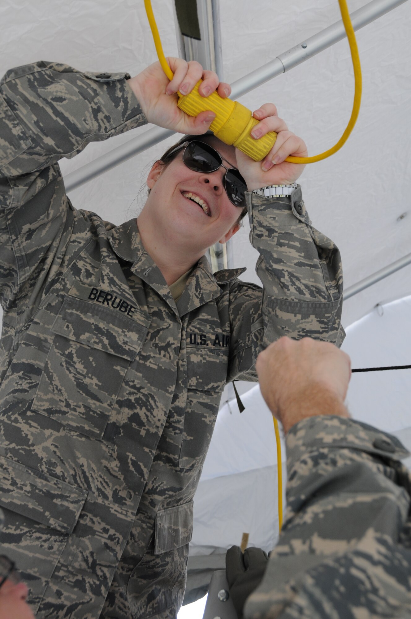 Senior Airman Lisa Berube, 192nd Fighter Wing, Medical Group specialist, connects light to a power cord during an exercise at Langley Air Force Base, April 7.  192nd MDG is one of four elements that is part of the Virginia National Guard’s special response force for Chemical Biological Radiological Nuclear High Yield Explosive Response Force Package, known as the CERFP (pronounced “surf-p”).  The CERFP can conduct tasks associated with incident management, urban search and rescue, mass causality decontamination, technical decontamination, medical triage and treatment and fatality search and recovery.  (U.S. Air National Guard photo by Master Sgt. Carlos J. Claudio/Released)