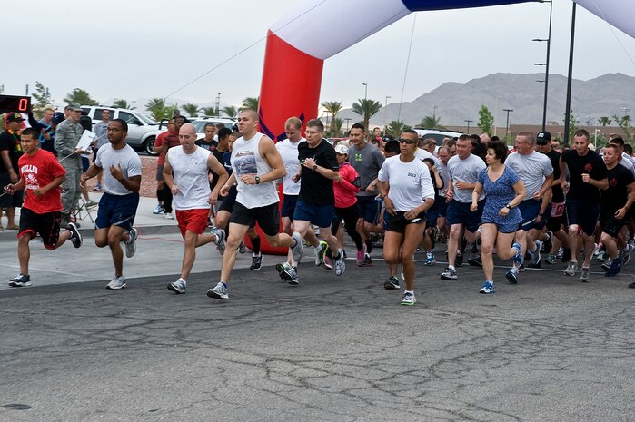 Members from the Nellis community participate in the Resiliency Day 5 kilometer race May 17, 2013, at Nellis Air Force Base, Nev. The 5K was one of the many events happening on Resiliency Day along with a health fair, blood drive and a Department of Transportation safety briefing. (U.S. Air Force photo by Senior Airman Matthew Lancaster)
