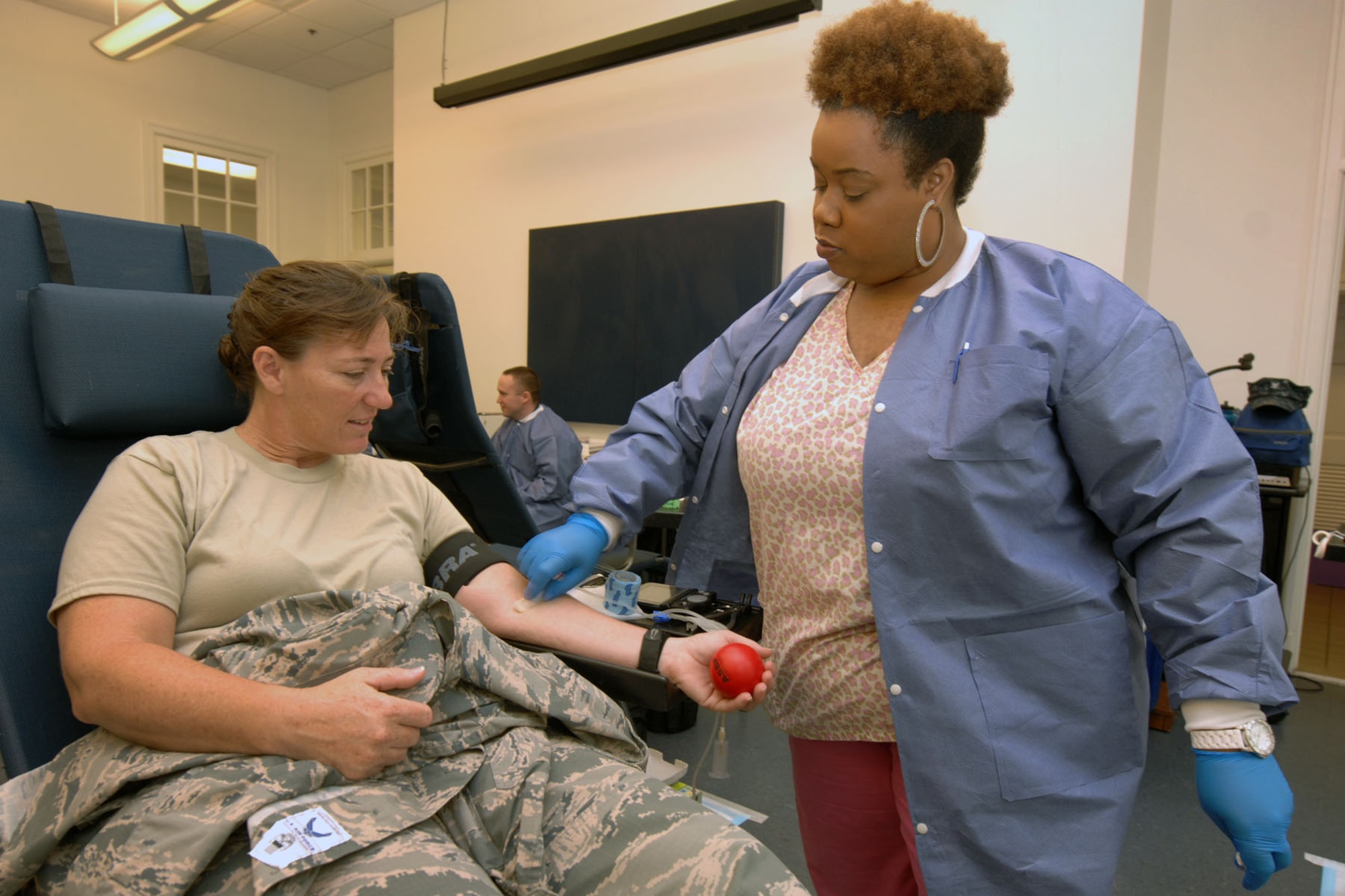 Antiya Sutton (right), a phlebotomist from Naval Medical Center Portsmouth, draws blood from Chief Master Sgt. Diane Hansen, Headquarters Air Combat Command F-22 Raptor Weapons Systems Team superintendent, during an Armed Services Blood Program blood drive at Langley Air Force Base, Va., May 21, 2013. The ASBP hosts blood drives monthly to encourage military and civilian personnel to donate blood for Service members deployed to warzones and at base military treatment facilities. (U.S. Air Force photo by Staff Sgt. Jeff Nevison/Released)