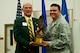 MG (ret) Bruce Smith, Chairman, Order of Daedalians Foundation, presents Lt. Col. Gabriel Lopez, 99th Logistics Readiness Squadron commander, with the Daedalian Maj. Gen. Warren R. Carter Logistics Effectiveness Award during a ceremony May 21, 2013, at Nellis Air Force Base, Nev. The 99th LRS competed against 219 other LRS organizations across the U.S. Air Force and was chosen as the best LRS in the Air Force. (U.S. Air Force photo/Senior Airman Brett Clashman)
