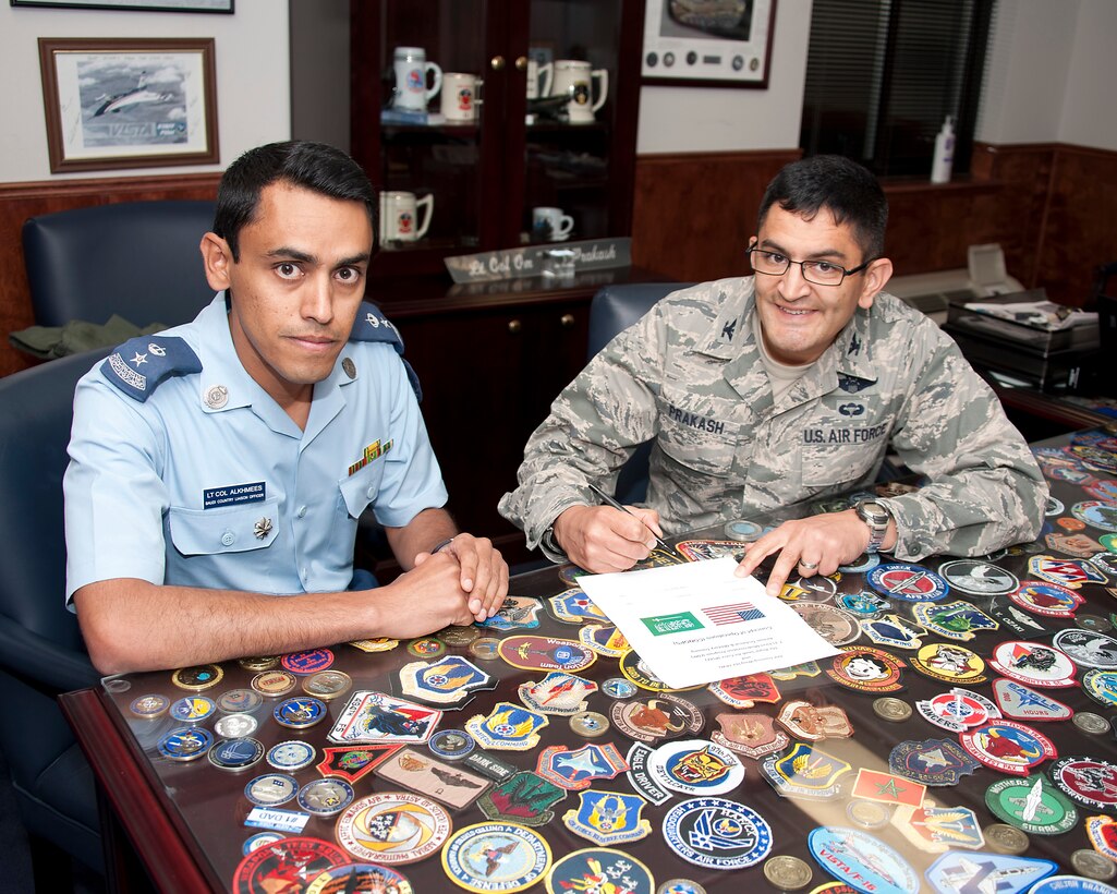Col. Om Prakash, 82nd Training Wing vice commander, Sheppard Air Force Base, Texas, and Royal Saudi Air Force Lt. Col. Abdulrahman Alkhmees, the senior liaison officer signs the Concept of Operations, sign a concept of operation agreement at Sheppard May, 21, 2013. The agreement describes the mission, organization, roles, responsibilities and technical training operation in terms necessary to support the RSAF transition to the F-15. (U.S. Air Force Photo Danny Webb/Released) 