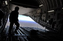 Master Sgt. Michael Folker, 326th Airlift Squadron loadmaster, locks in and prepares for reverse taxi operations prior to a noncombatant evacuation as part of Operation Bunny Flag May 3-5, 2013, Nellis Air Force Base, Nev. More than 50 Liberty Wing Airmen participated in Operation Bunny Flag to provide a layout for future Red Flag operations planning. (U.S. Air Force photo/Senior Airman Erika Brooke)
