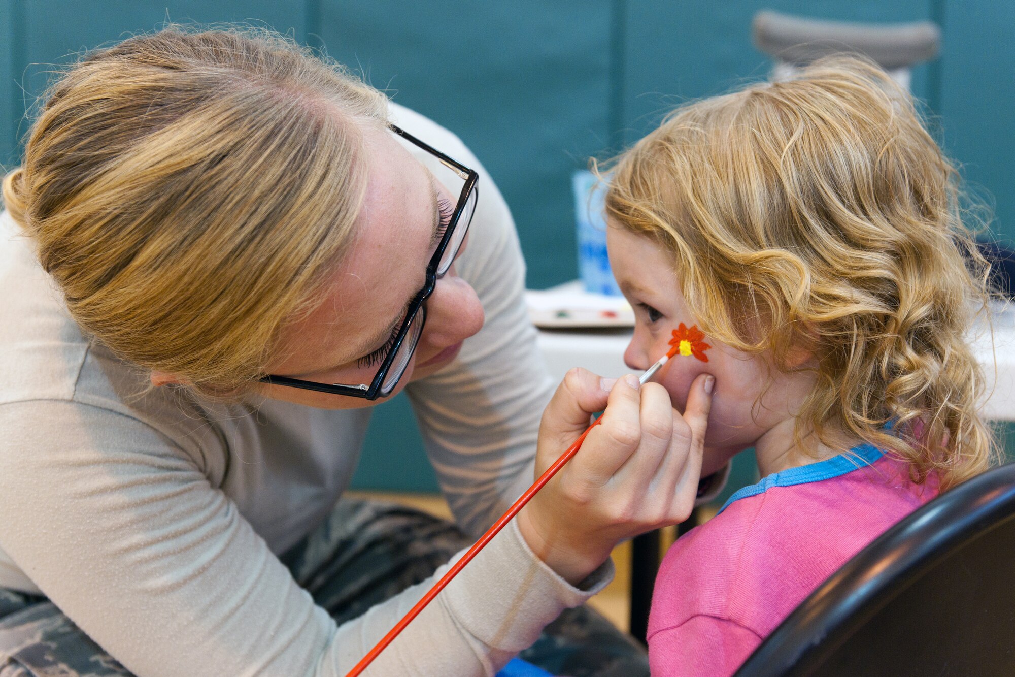 RAF ALCONBURY, United Kingdom – Airman 1st Class Kylie Cain, 423rd Security Forces Squadron, paints Ella Cunningham’s face during the National Police Week Carnival held at RAF Alconbury May 18. Security forces squadrons across the 501st Combat Support Wing celebrated National Police Week from May 13 to 18 with events and ceremonies honoring the security forces Airmen, Air Force Office of Special Investigations agents, Ministry of Defense police officers and all other law enforcement officers throughout the world who have made the ultimate sacrifice for their countries. (U.S. Air Force photo by Staff Sgt. Brian Stives)