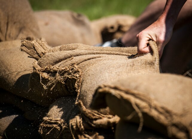 An Airmen from the from the 628th Security Forces Squadron forms a Defensive Fighting Position with sandbags during the Police Week Guns and Hoses competition May 15, 2013, at Joint Base Charleston – Air Base, S.C. The 628th Security Forces Squadron hosted events including the "Guns and Hoses" fitness challenge, a shooting competition, chili cook-off and a retreat ceremony. National Police Week recognizes the services and sacrifices of U.S. law enforcement personnel. (U.S. Air Force photo/ Senior Airman Dennis Sloan)