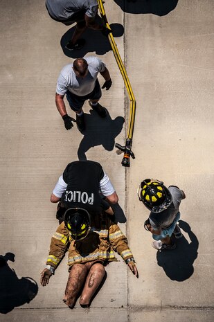 Airmen from the 628th Security Forces Squadron conduct a fireman’s carry during the Police Week Guns and Hoses competition May 15, 2013, at Joint Base Charleston – Air Base, S.C. The 628th Security Forces Squadron hosted events including the "Guns and Hoses" fitness challenge, a shooting competition, chili cook-off and a retreat ceremony. National Police Week recognizes the services and sacrifices of U.S. law enforcement personnel. (U.S. Air Force photo/ Senior Airman Dennis Sloan)