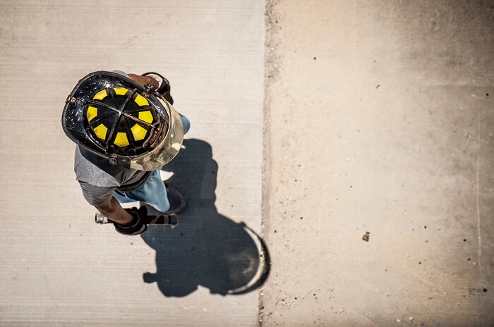 A 628th Civil Engineer Squadron crew chief holds the competition team baton before starting the Police Week Guns and Hoses competition, May 15, 2013, at Joint Base Charleston – Air Base, S.C. The 628th Security Forces Squadron hosted events for National Police Week, including the "Guns and Hoses" fitness challenge, a shooting competition, chili cook-off and a retreat ceremony. National Police Week recognizes the services and sacrifices of U.S. law enforcement personnel. (U.S. Air Force photo/ Senior Airman Dennis Sloan)