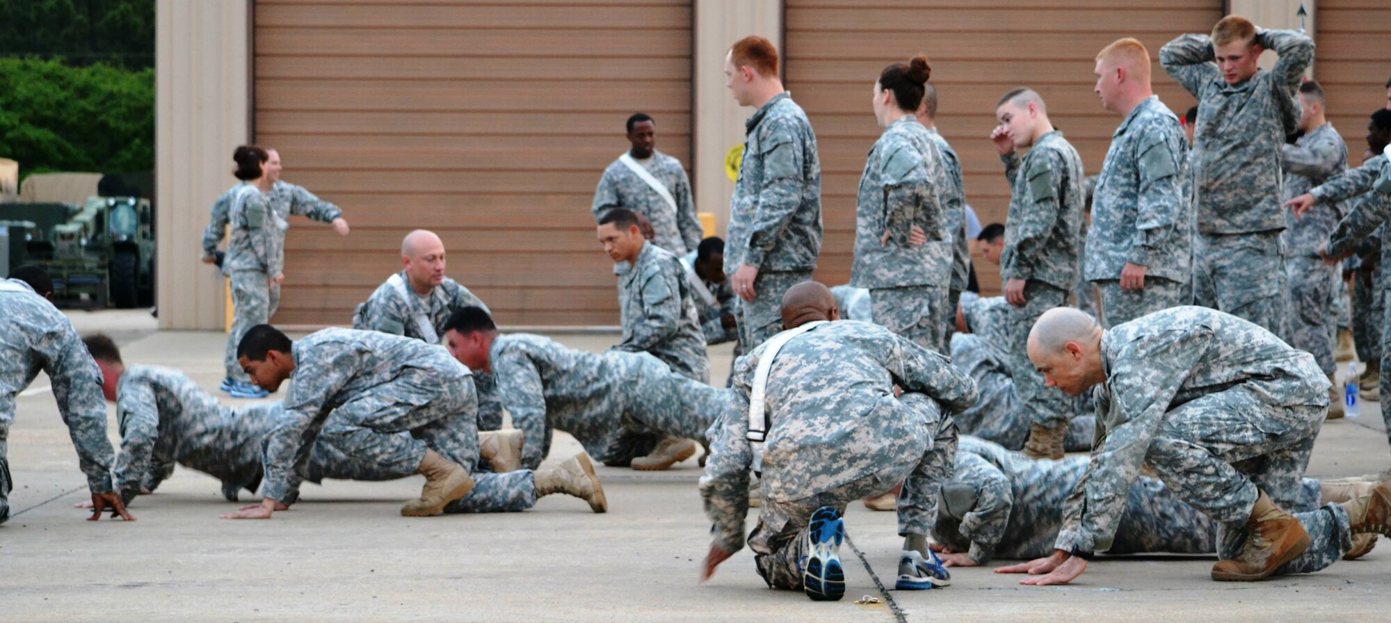 Soldiers from the 10th Transportation Battalion, 7th Sustainment Brigade work in pairs to complete a total of 500 push-ups and sit-ups during a pre-dawn squad fitness competition at Fort Eustis, Va., May 17, 2013. In addition to push-ups and sit-ups, Soldiers representing the battalion’s companies performed a 1.5-mile litter carry, 100-yard Humvee push, litter carries in a pool, and a seven-mile ruck march, all to determine which company could earn the coveted “Waterborne Belt.” (U.S. Army photo by Sgt. 1st Class Brian G. Rhodes/Released)
