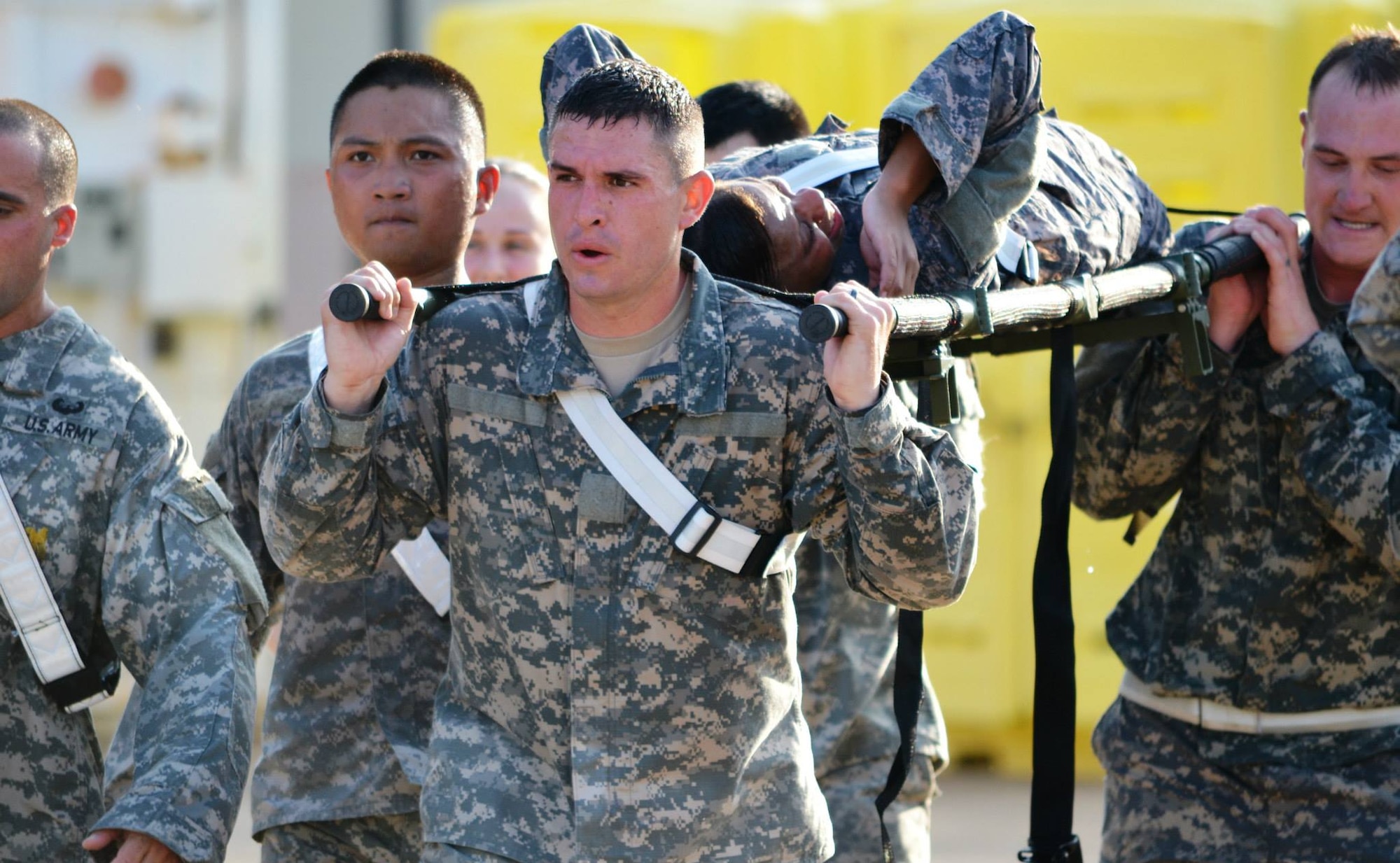 Soldiers from the 10th Transportation Battalion, 7th Sustainment Brigade carry a simulated casualty and sandbags across the finish line at the battalion motor pool during a pre-dawn squad fitness competition at Fort Eustis, Va., May 17, 2013. Soldiers from the 97th Trans. Company crossed the finish line first, earning the coveted “Waterborne Belt.” (U.S. Army photo by Sgt. 1st Class Brian G. Rhodes/Released)