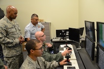 Chief Master Sgt. Gerardo Tapia, Air Education and Training Command command
chief, and Chief Master Sgt. Woolridge, 12th Flying Training Wing command
chief, receive a demonstration on a simulator used for remotely piloted
aircraft training from a 558th Flying Training Squadron instructor and basic
sensor operator student.  Tapia visited the 12th Flying Training Wing at
Joint Base San Antonio-Randolph, Texas, May 20, 2013. (U.S. Air Force photo
by Joel Martinez)
