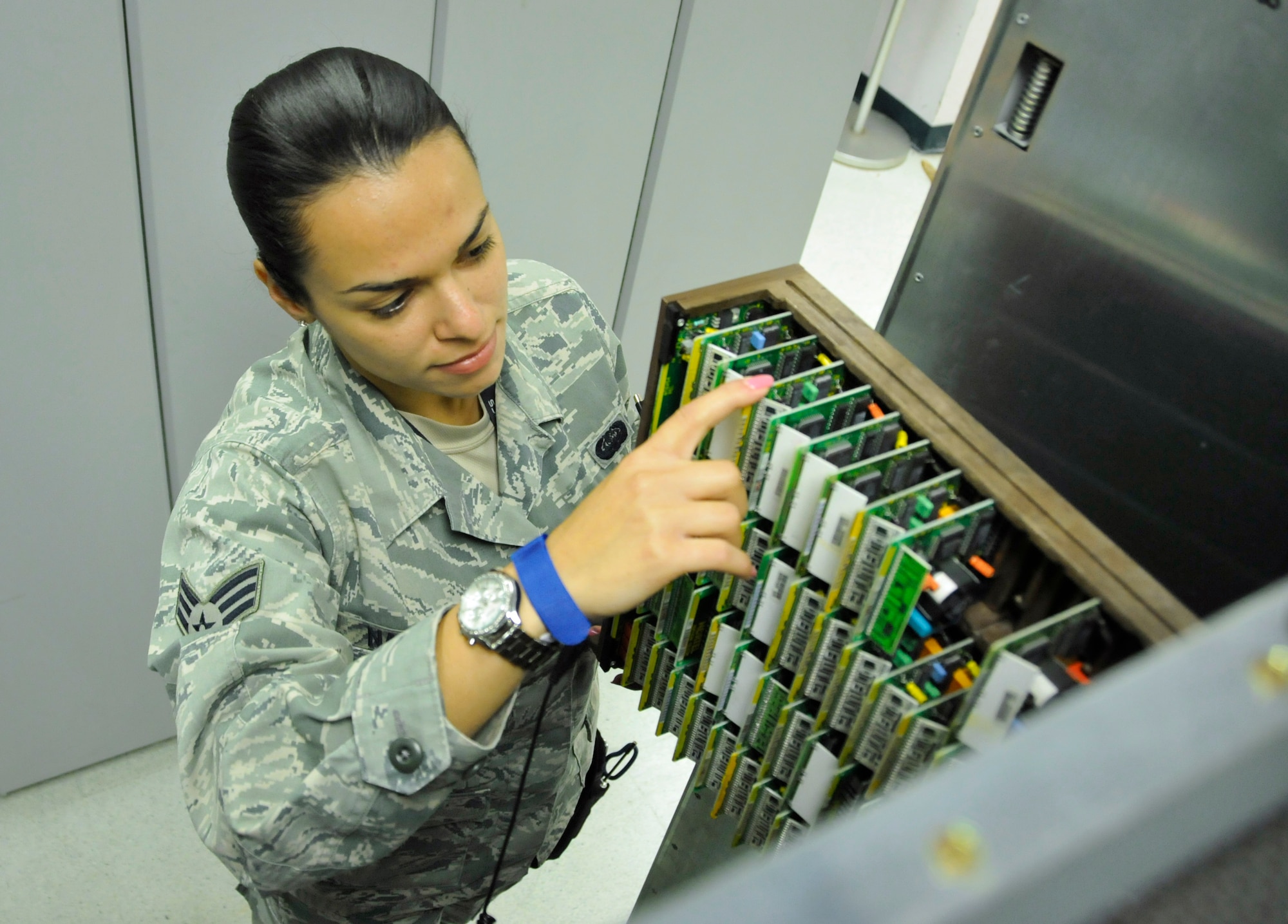 Senior Airman Sharon Navarro, 482nd Communications Squadron knowledge operations manager, checks telecommunications circuits in the Telephone Central Office at Homestead Air Reserve Base, Fla., Mar. 14. The Telephone Central Office hosts all of Homestead ARB’s phone lines, alarm circuits, commercial communications lines, and television services. (U.S. Air Force photo/Senior Airman Nicholas Caceres) 

