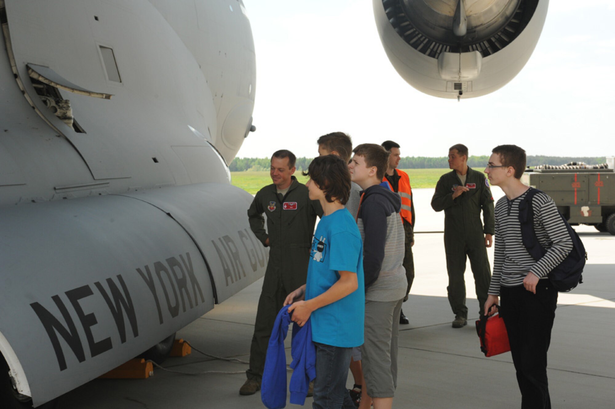 U.S. Air Force Capt. Kyle Lukey, a 176th Fighter Squadron F-16 Fighting Falcon fighter aircraft pilot with the 115th Fighter Wing Air National Guard, explains the features of a C-17 Globemaster III cargo aircraft to local high school students during a community outreach day May 15, 2013. Nearly 100 members of the 115th FW came to Poland as part of a joint theater security cooperation event taking place May 13-24, 2013. More than 50 students were invited to Lask Air Base, Poland to view U.S. and Polish aircraft, interact with pilots and support personnel and tour base facilities. (U.S. Air Force photo by Tech. Sgt. Kenya Shiloh/released)