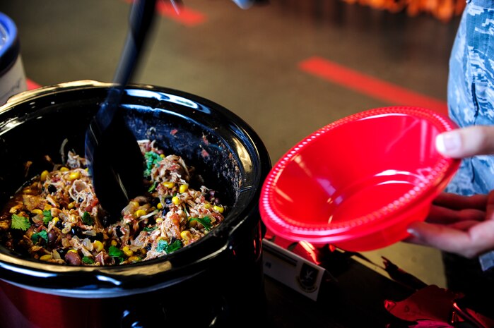 A 628th Security Forces Squadron member serves some chili to the judges  during the 628th SFS Chili Cook-off May 15, 2013 at Joint Base Charleston – Air Base, S.C. The JB Charleston commander and 437th Airlift Wing commander judged the chili cook-off. The 628th Security Forces Squadron hosted events including the "Guns and Hoses" fitness challenge, a shooting competition, chili cook-off and a retreat ceremony. National Police Week recognizes the services and sacrifices of U.S. law enforcement personnel. (U.S. Air Force photo/Staff Sgt. Rasheen Douglas)