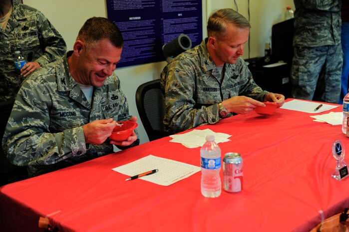 Col. Richard McComb, Joint Base Charleston commander, and Col. Darren Hartford, 437th Airlift Wing commander, judge the chili entries during the 628th Security Forces Squadron Chili Cook Off May 14, 2013, at Joint Base Charleston - Air Base, S.C. The 628th Security Forces Squadron hosted events including the "Guns and Hoses" fitness challenge, a shooting competition, chili cook-off and a retreat ceremony. National Police Week recognizes the services and sacrifices of U.S. law enforcement personnel. (U.S. Air Force photo/Staff Sgt. Rasheen Douglas)