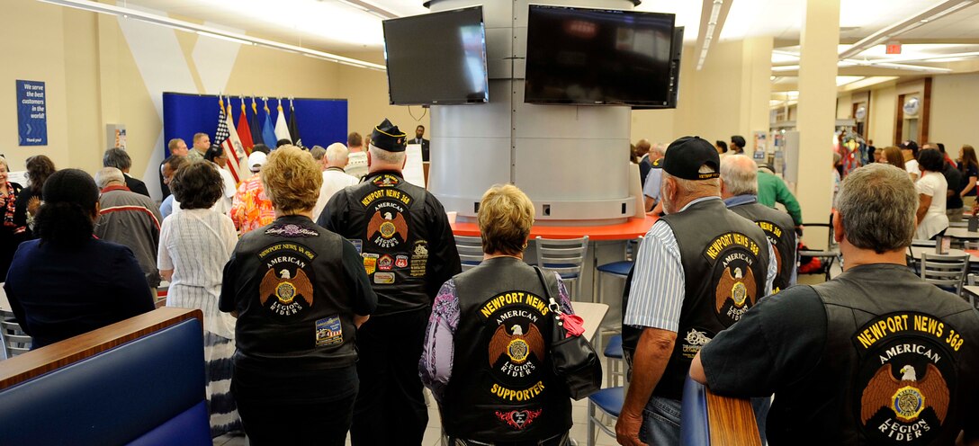 Retirees stand for the playing of the Army, Air Force, Marine, Navy and Coast Guard songs during the annual Retiree Appreciation Day at Fort Eustis, Va., May 18, 2013. Retiree Appreciation Day provides networking opportunities and resources for retirees and their family members. (U.S. Air Force photo by Staff Sgt. Dana Hill/Released)