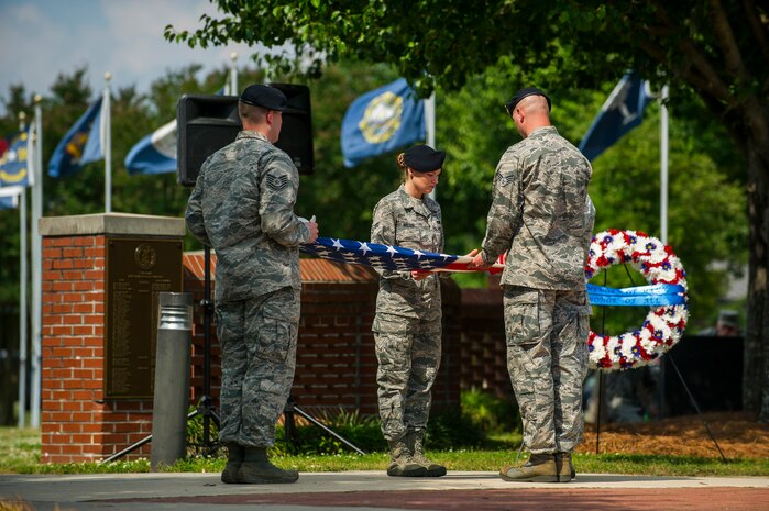 Tech. Sgt. Shaun Horn, 628th Security Forces Squadron flight chief, Staff Sgt. Adam Thompson, 628th SFS Combat Arms Training and Maintenance instructor, Senior Airman Jonathan Breed, 628th SFS armorer, and Airman 1st Class Heather Miller, 628th SFS patrolman, perform flag detail during the Police Week Retreat ceremony May 17, 2013, at Joint Base Charleston - Air Base, S.C. The 628th Security Forces Squadron hosted events including the "Guns and Hoses" fitness challenge, a shooting competition, chili cook-off and a retreat ceremony. National Police Week recognizes the services and sacrifices of U.S. law enforcement personnel.  (U.S. Air Force photo/ Senior Airman George Goslin)