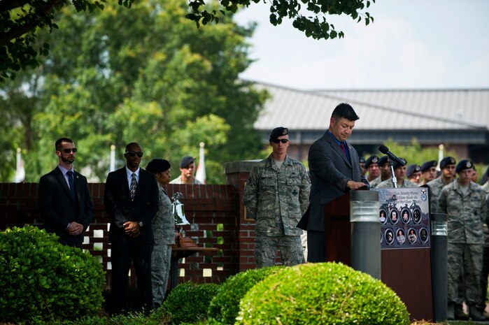 Fernando Martinez, Office of Special Investigations Detachment 310 special agent, reads off the names of fallen officers during the Police Week Retreat ceremony May 17, 2013, at Joint Base Charleston - Air Base, S.C. The 628th Security Forces Squadron hosted events including the "Guns and Hoses" fitness challenge, a shooting competition, chili cook-off and a retreat ceremony. National Police Week recognizes the services and sacrifices of U.S. law enforcement personnel. (U.S. Air Force photo/ Senior Airman George Goslin)