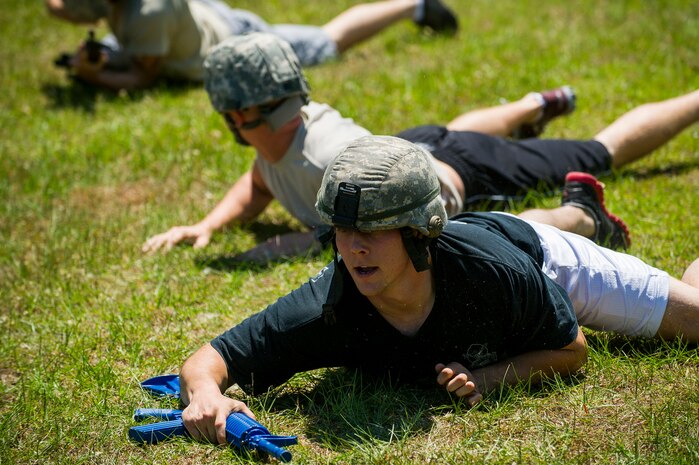 Members of the 628th Security Forces Squadron team crawl toward an objective during the Police Week Guns and Hoses competition May 15, 2013, at Joint Base Charleston - Air Base, S.C. The 628th Security Forces Squadron hosted events including the "Guns and Hoses" fitness challenge, a shooting competition, chili cook-off and a retreat ceremony. National Police Week recognizes the services and sacrifices of U.S. law enforcement personnel. (U.S. Air Force photo/ Senior Airman George Goslin)