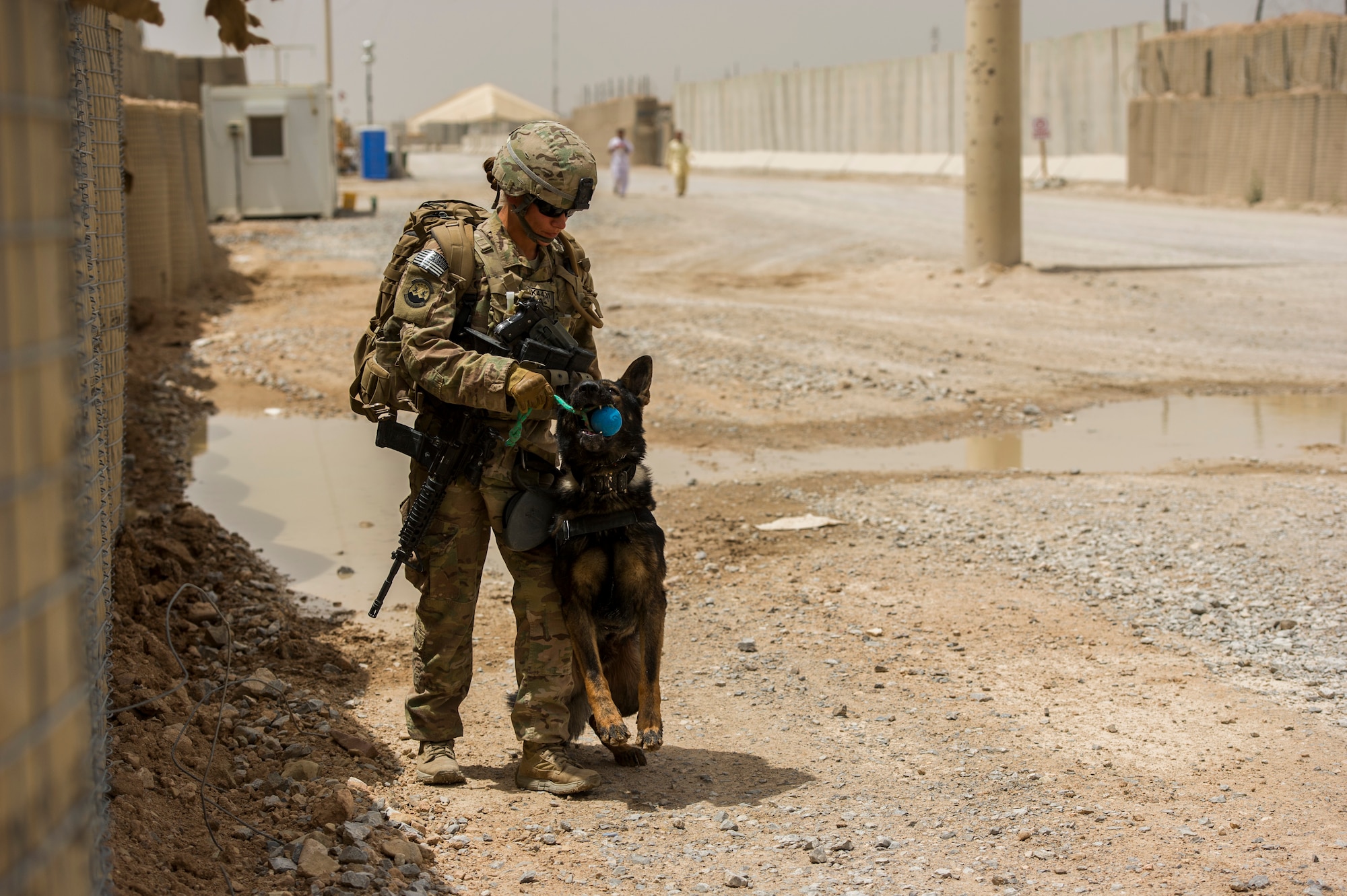 U.S. Air Force Staff Sgt. Jessie Johnson, 3rd Infantry Division military working dog handler, plays with her dog, Chrach, before their explosives detection training, at Forward Operation Base Pasab, Afghanistan, April 24, 2013. Chrach is trained to detect the odor of explosives. Johnson, a native of Reading, Pa., has been a MWD handler for four years and is deployed from Luke Air Force Base, Ariz. (U.S. Air Force photo/Staff Sgt. Marleah Miller)