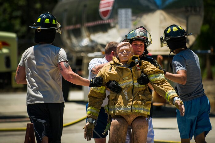 Stephen Hackworth, 628th Security Forces Squadron patrolman, drags a dummy during the Police Week Guns and Hoses competition May 15, 2013, at Joint Base Charleston - Air Base, S.C. The 628th Security Forces Squadron hosted events including the "Guns and Hoses" fitness challenge, a shooting competition, chili cook-off and a retreat ceremony. National Police Week recognizes the services and sacrifices of U.S. law enforcement personnel. (U.S. Air Force photo/ Senior Airman George Goslin)