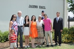 The family of the late Air Force Maj. Peter Jahns ,Air Force Col. Steven Parker (back), 340th Flying Training Group commander, and retired Air Force Lt. Col. JK Switzer (right) pose in front of the newly dedicated 39th Flying Training Squadron building Friday at Joint Base San Antonio-Randolph. Jahns, a former T-38 instructor pilot, died in a crash March 19, 2003, during a routine training flight at Randolph. (Air Force photo by Richard McFadden)