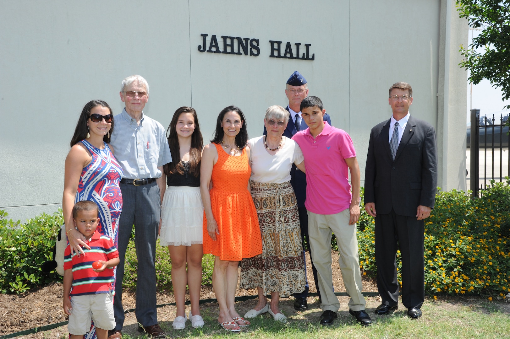The family of the late Air Force Maj. Peter Jahns ,Air Force Col. Steven Parker (back), 340th Flying Training Group commander, and retired Air Force Lt. Col. JK Switzer (right) pose in front of the newly dedicated 39th Flying Training Squadron building Friday at Joint Base San Antonio-Randolph. Jahns, a former T-38 instructor pilot, died in a crash March 19, 2003, during a routine training flight at Randolph. (Air Force photo by Richard McFadden)