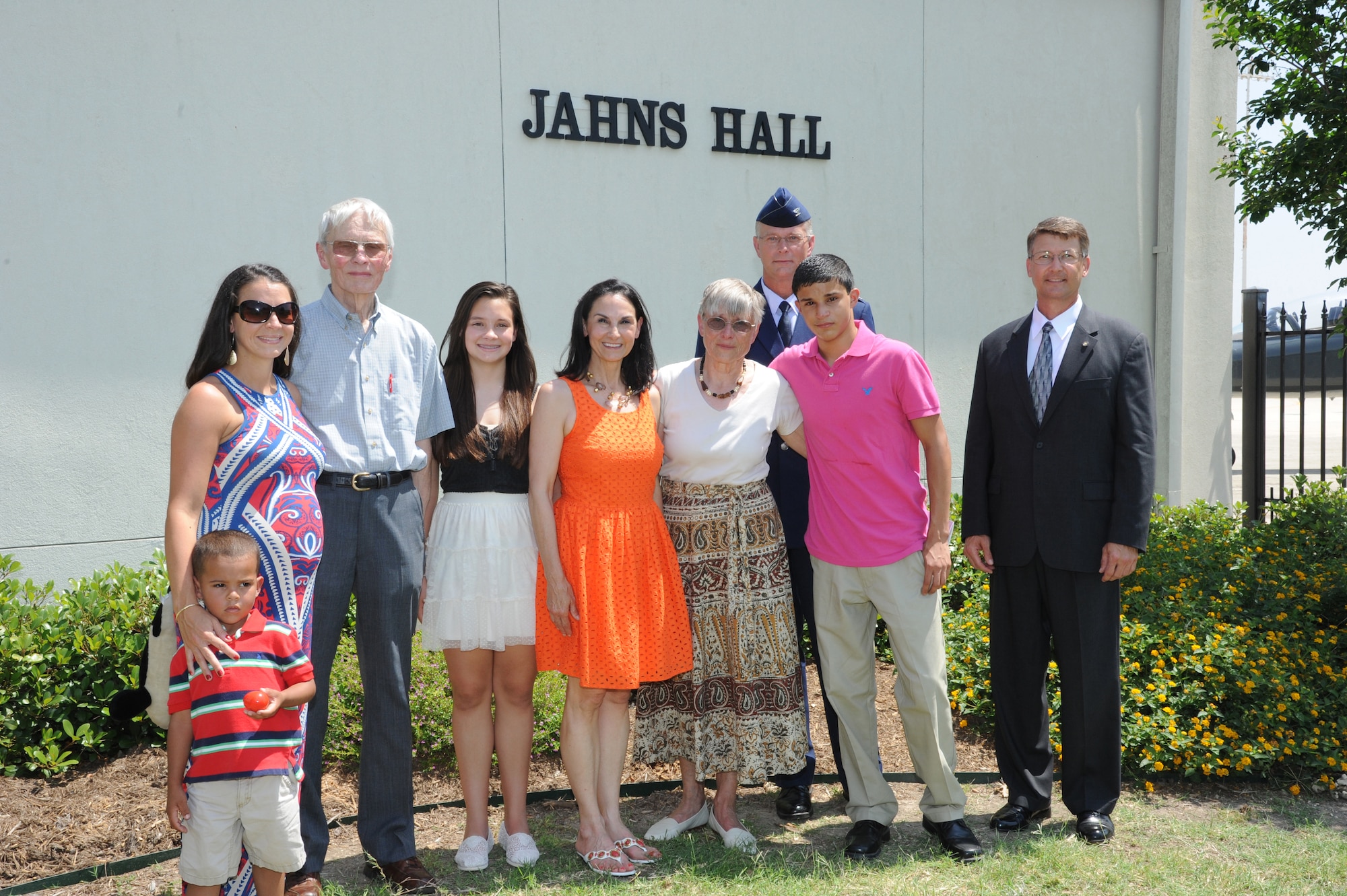The family of the late Air Force Maj. Peter Jahns ,Air Force Col. Steven Parker (back), 340th Flying Training Group commander, and retired Air Force Lt. Col. JK Switzer (right) pose in front of the newly dedicated 39th Flying Training Squadron building Friday at Joint Base San Antonio-Randolph. Jahns, a former T-38 instructor pilot, died in a crash March 19, 2003, during a routine training flight at Randolph. (Air Force photo by Richard McFadden)