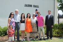 The family of the late Air Force Maj. Peter Jahns ,Air Force Col. Steven Parker (back), 340th Flying Training Group commander, and retired Air Force Lt. Col. JK Switzer (right) pose in front of the newly dedicated 39th Flying Training Squadron building Friday at Joint Base San Antonio-Randolph. Jahns, a former T-38 instructor pilot, died in a crash March 19, 2003, during a routine training flight at Randolph. (Air Force photo by Richard McFadden)