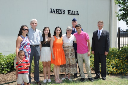 The family of the late Air Force Maj. Peter Jahns ,Air Force Col. Steven Parker (back), 340th Flying Training Group commander, and retired Air Force Lt. Col. JK Switzer (right) pose in front of the newly dedicated 39th Flying Training Squadron building Friday at Joint Base San Antonio-Randolph. Jahns, a former T-38 instructor pilot, died in a crash March 19, 2003, during a routine training flight at Randolph. (Air Force photo by Richard McFadden)