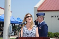 Regina Nicks sings the National Anthem at the dedication of  Jahns Hall, building 39 at Joint Base San Antonio-Randolph, May 17, 2013. Maj. Peter "Oly" Jahns, a former T-38 instructor pilot, died in a crash March 19, 2003, during a routine training flight at Randolph. (Air Force photo by Richard McFadden)