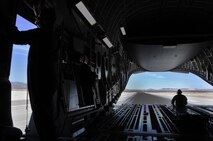 Master Sgts. Michael Folker and John Kaffka, 326th Airlift Squadron loadmasters, direct pilots during reverse taxi operations on the runway prior to conducting a simulated noncombatant evacuation operation as part of Operation Bunny Flag May 3-5, 2013, Nellis Air Force Base, Nev. More than 50 Liberty Wing Airmen participated in the three-day training event, which provided a layout for future Red Flag operations planning. (U.S. Air Force photo/Senior Airman Erika Brooke) 