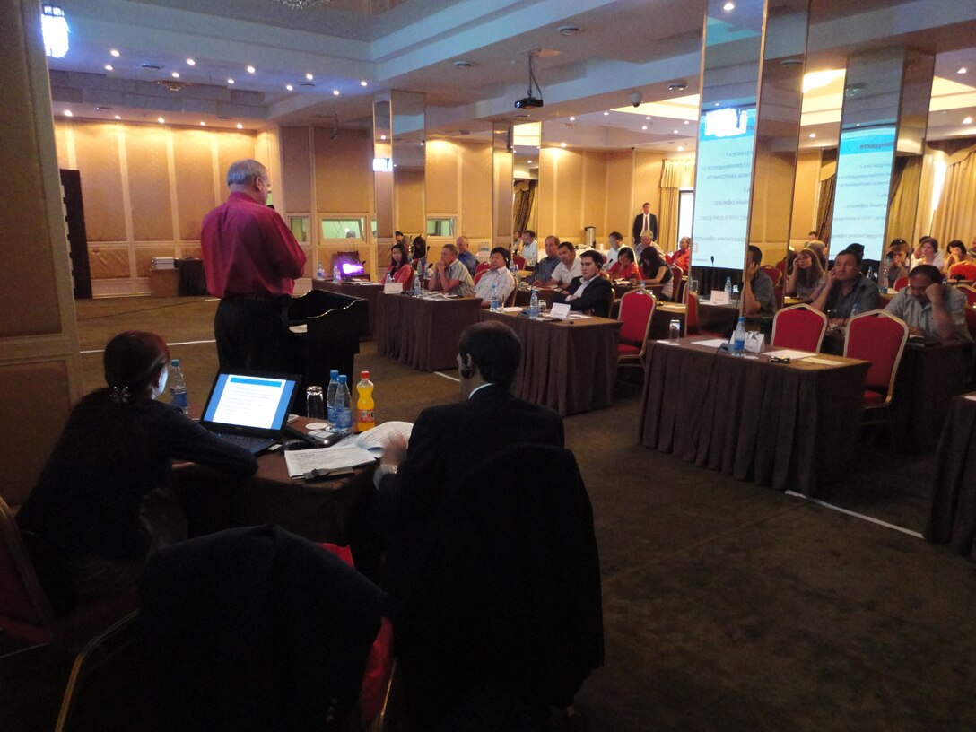 More than 65 contractor representatives listen as Robert Strom describes counternarcotics projects and contracting requirements. Interpreters assisted during the presentations. (USACE photo – Mike Weaver)