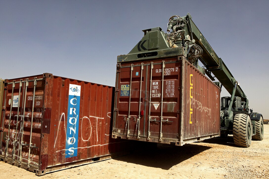 A U.S. Marine lifts a container using a Kalmar RT240 rough terrain container handler after conducting a combat logistics patrol to combat outpost Shir Ghazi in Helmand province, Afghanistan, May 19, 2013.