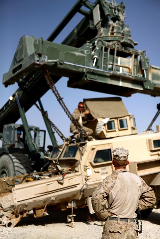 U.S. Marine Corps Sgt. Dennis Emke oversees the loading of a damaged