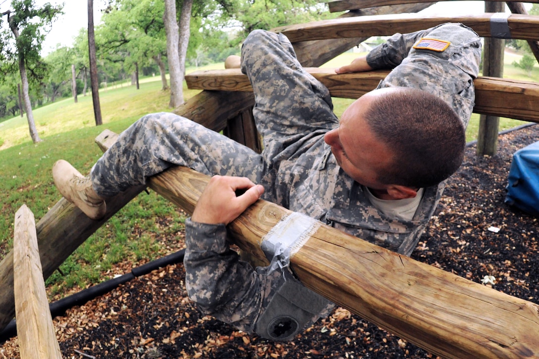 Army Staff Sgt. Jacob Dipietro navigates an obstacle course during the ...