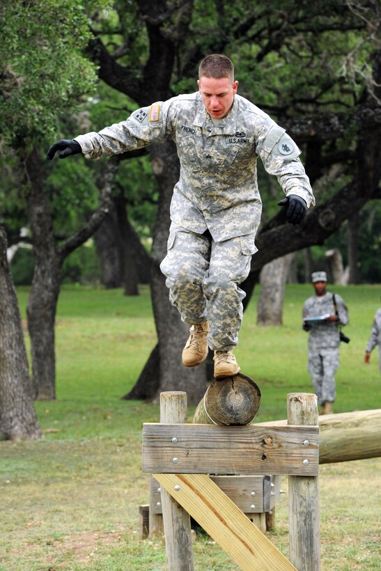Army Sgt. Andrew French jumps off a log balance on Camp Bullis, Texas, May 15, 2013. French is assigned to the 512th Geospatial Engineering Detachment on Fort Sam Houston, Texas.