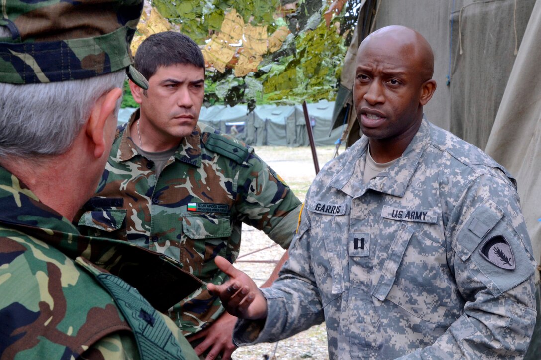 U.S. Army Cpt. Willie Garris, right, talks with Bulgarian army Brig. Gen Lyubcho Todorov, left, and a battle staff member during Thracian Guard 2013 on Novo Selo Training Area, Bulgaria, May 14, 2013.
