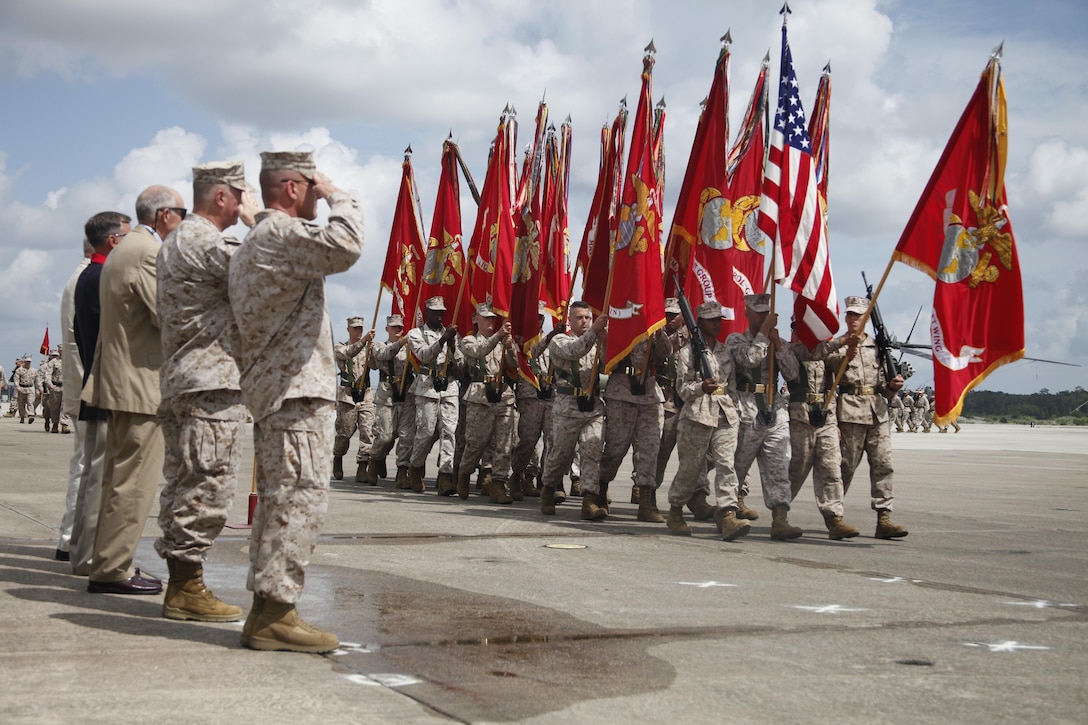 Brig. Gen. Robert F. Hedelund, right, the commanding general of the 2nd Marine Aircraft Wing, salutes the colors alongside Maj. Gen. Glenn M. Walters and other former commanding generals of the wing during a change of command ceremony at Cherry Point May 22.