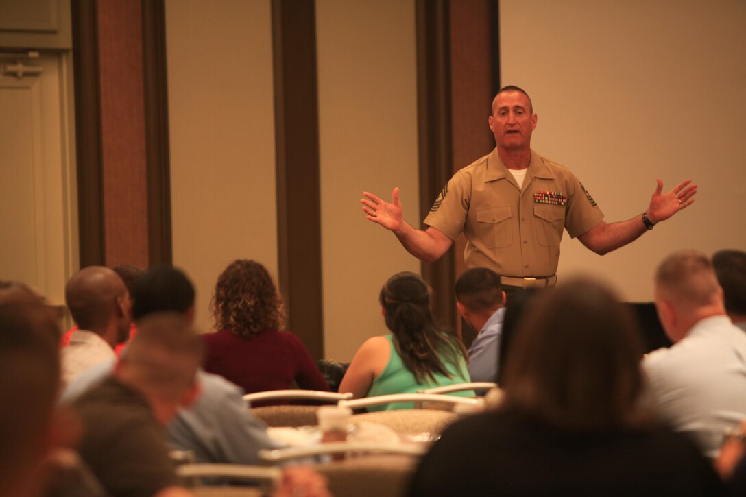 Sgt. Maj. Richard Lewallen, sergeant major of the 4th Marine Logistics Group, addresses the audience at the 4th MLG’s 2013 Yellow Ribbon Reintegration Program conference, May 18. The conference provided Marines and their families with advice and resources to help with pre- and post-deployment challenges, as well as how to adjust to a civilian workplace environment. 