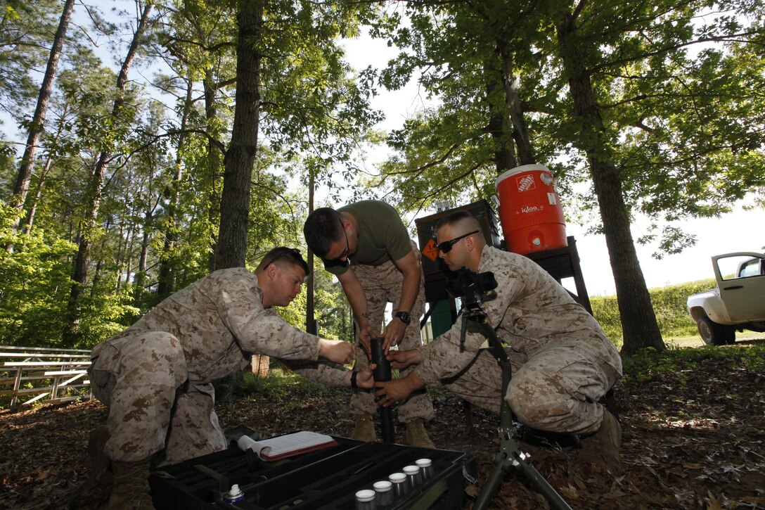 (From left) Master Sgt. William Walker, the Explosive Ordnance Disposal staff noncommissioned officer in charge, Gunnery Sgt. Bernard Coyne and Staff Sgt. Travis McGlew, explosive ordnance technicians, assemble the MK 40 Mod 0 Unexploded Ordnance Standoff Disrupter at Cherry Point May 16. 