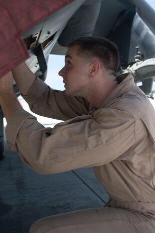 Sgt. Joshua C. Cowan, an AV-8B Harrier powerline mechanic with Marine Attack Squadron 542, inspects a Harrier May 21. Cowan received the VMA-542 Maintenance Marine of the Year award during a ceremony at the Twin Rivers Theater aboard Cherry Point May 13. 