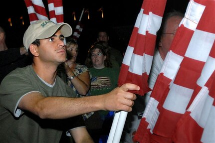 Army Pfc. Mohamed Mustafa, Virginia Army National Guard soldier and George Mason University ROTC cadet, participates in an American flag dedication at the Pentagon Sept. 10, 2008. The dedication was headed by the Healing Field Foundation, and about 200 volunteers were on hand to place and set up nearly 3,000 American flags in the Pentagon parking lot in honor of the victims and families of the 9/11 attacks.