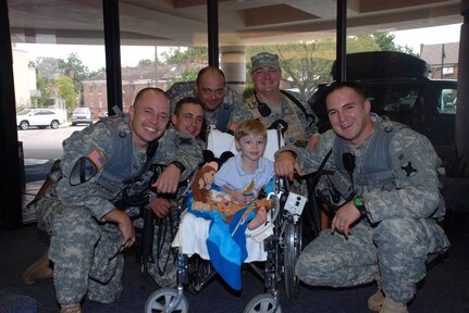 Louisiana National Guardsmen of Troop B, 2nd Squadron, 108th Cavalry, pose with Cameron Bayley, the youngest spur holder in their troop . From the left are 1st Sgt. Tim D. McKnight, Sgt. Jesse G. Kennedy, Sgt. 1st Class Roy Nugent, Staff Sgt. Jason Doughty and 1st Lt. Tom H. Mesloh, all of the Shreveport/Bossier City area.