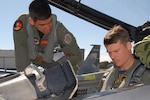 Major David Yao, 173rd Fighter Wing (FW) instructor pilot, Oregon Air National Guard, discussed the F-15 Eagle with Royal Australian Air Force (RAAF) F/A-18 Hornet pilot Flight Lieutenant James Atkinson, 2nd Operational Conversion Unit (OCU), during "Sentry Downunder" on August 26, 2008 at RAAF Williamtown, New South Wales, Australia. "Sentry Downunder" is a joint flight exercise with the 173rd FW, assisting the RAAF 2nd OCU advanced fighter weapons school conducted at RAAF Williamtown.