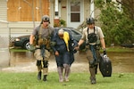 Joint Task Force 129 pararescuemen rescue a hurricane victim in Galveston, Texas, Sept. 13. The JTF 129 crews rescued a total of 10 civilians and pets stranded in the Galveston area.