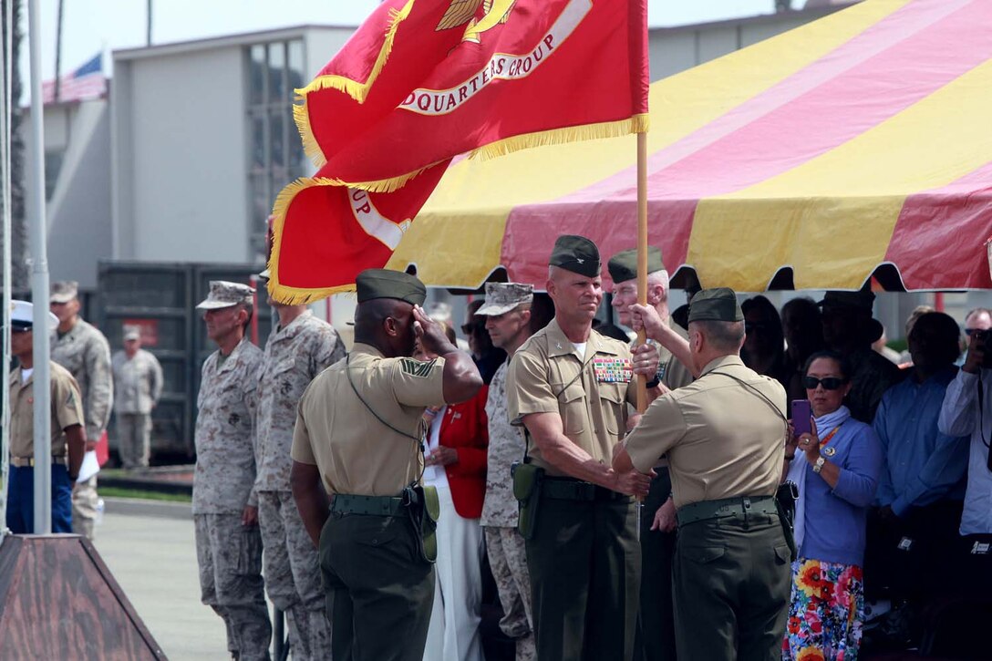 Col. James H. Herrera receives the colors from Col. Steven M. Hanson during a change of command ceremony at Camp Pendleton, May 21. During the ceremony Herrera relieved Hanson as the commanding officer of I Marine Expeditionary Force Headquarters Group. Hanson passed on I MHG's guidon to Herrera signifying his relinquishing of command and Herrera's new responsibilities.