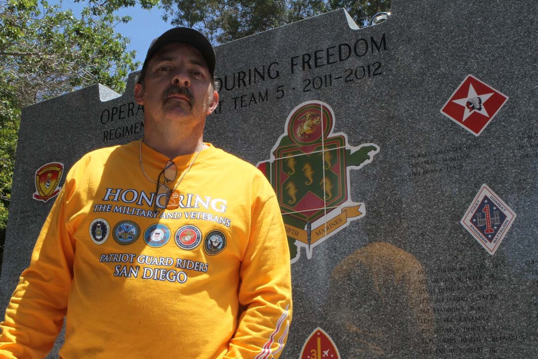 Henry Lafreniere, the truck driver who drove 5th Marine Regiment's Operation Enduring Freedom Memorial, stands in front of the 7-ton, Barre granite memorial at Camp San Mateo's Memorial Garden here, May 20, 2013. Henry, a native of Richmond, Vt., drove the memorial from Barre, Vt., to Camp Pendleton while being escorted by the Patriot Guard Riders during the course of 10 days.