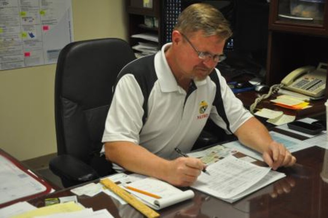 Neil Pinchefsky, deputy director of Fleet Support Division on Marine Corps Logistics Base Barstow, Calif., looks over reports before sending them up the chain of command, May 10. Pinchefsky ensures FSD meets their deadlines and completes their mission.
