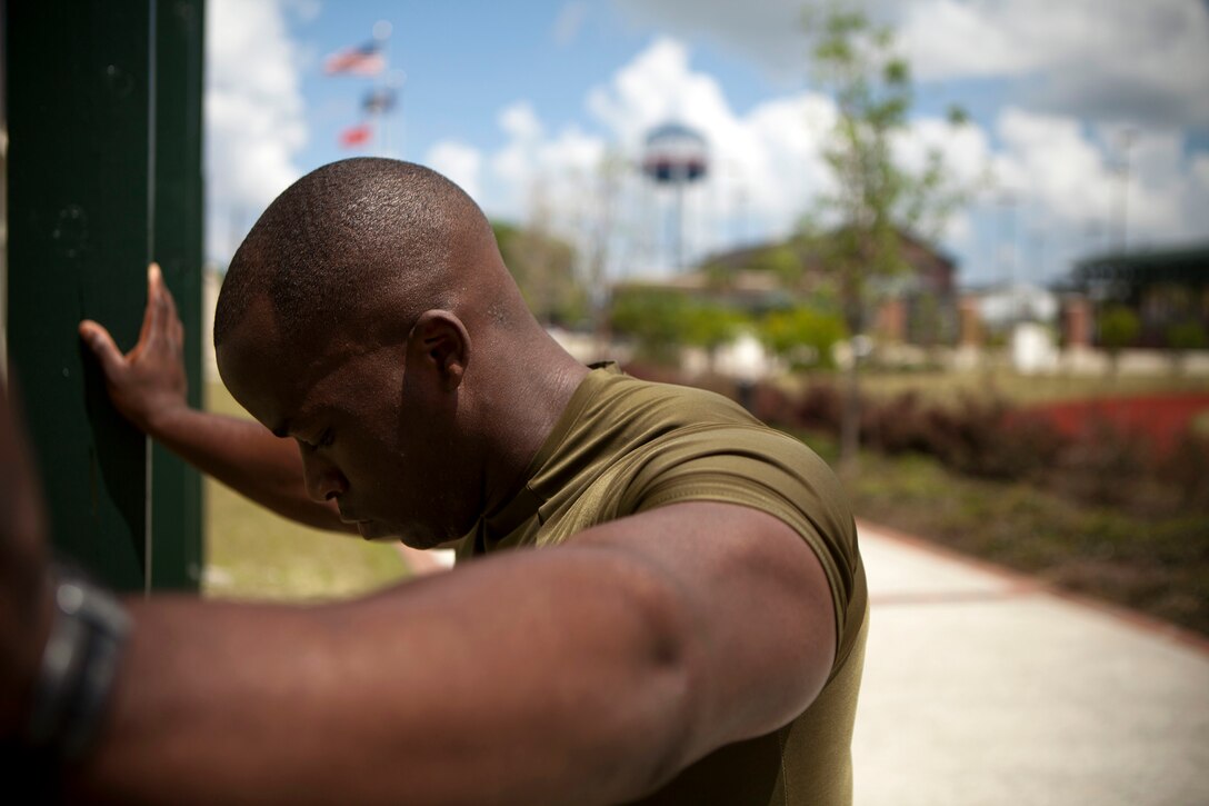 Sgt. Emmanuel Dickson, an administrative specialist with personnel sourcing, Marine Forces Reserve, takes a break after doing a set of pull-ups here, May 20. Dickson says he can currently perform 38 pull-ups in a row, and performs more than 100 pull-ups every day.  